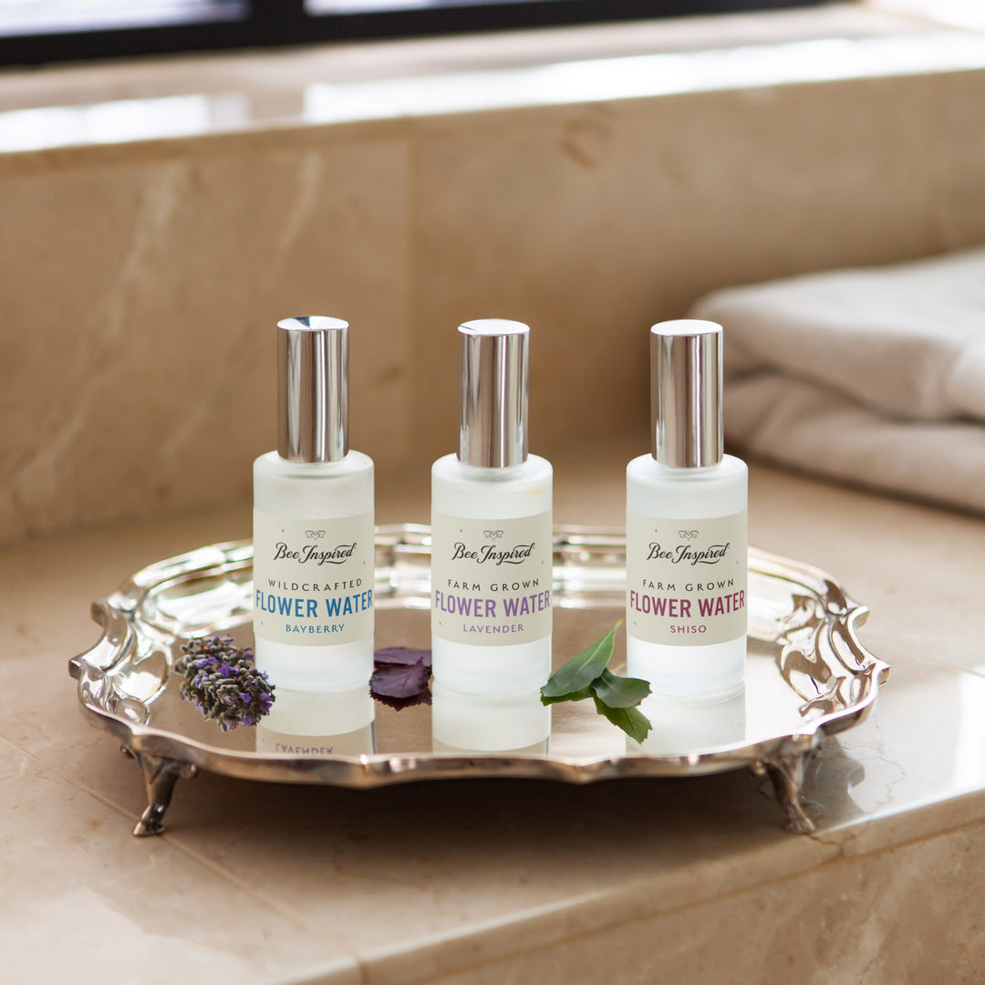 bayberry leaf flower water, lavender flower water, and shiso flower water lined up on a silver tray