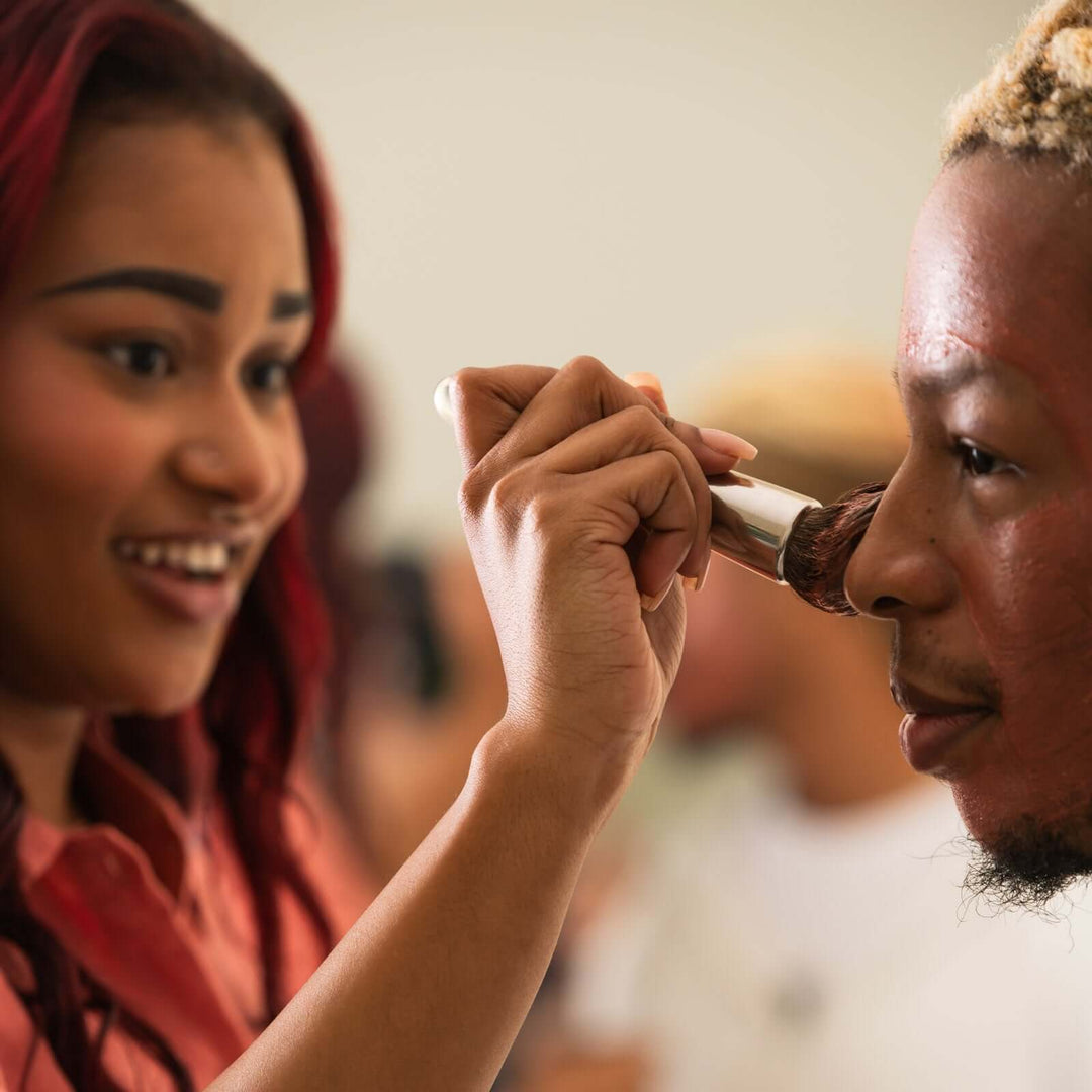 Woman brushes Clarity mask onto a man&