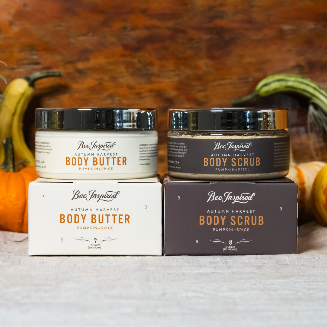 Bee Inspired body butter and body scrub with packaging on a rustic background