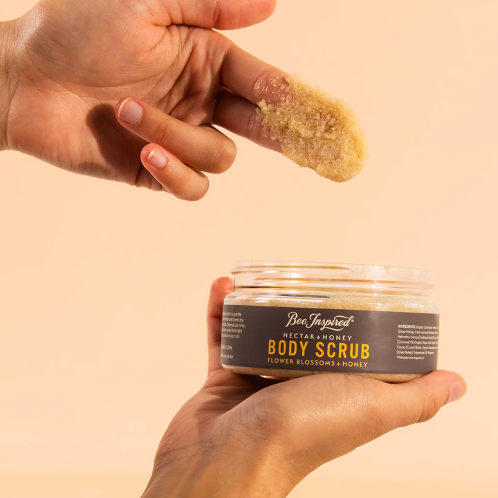 fingers with a scoop of nectar and honey body scrub