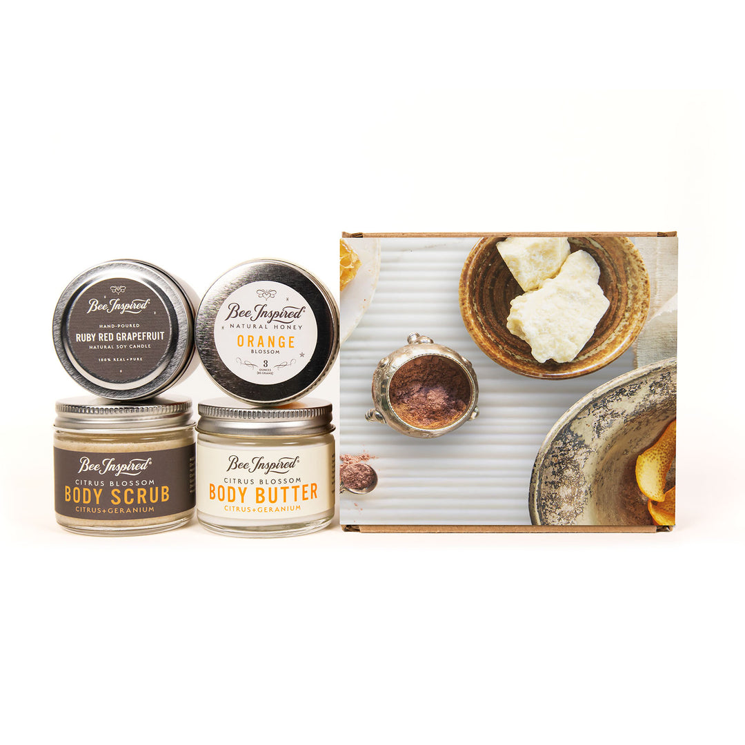 Set of body care products including tins and a box on a white background