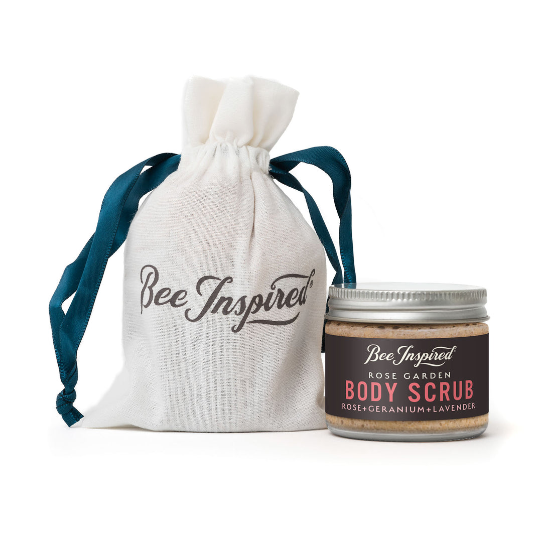Rose Garden Body scrub party favor with 'Bee Inspired' label next to a drawstring bag on a white background