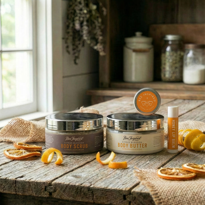 Body care products including body scrub, body butter, and lip balm on a wooden surface with a rustic background.