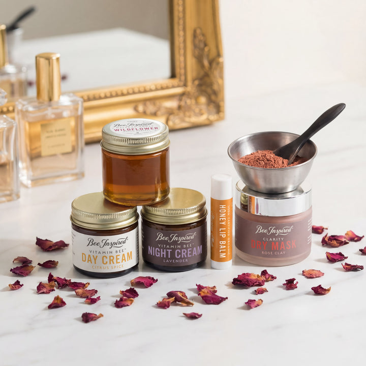 Collection of skincare products including jars and a lip balm on a surface with decorative elements.
