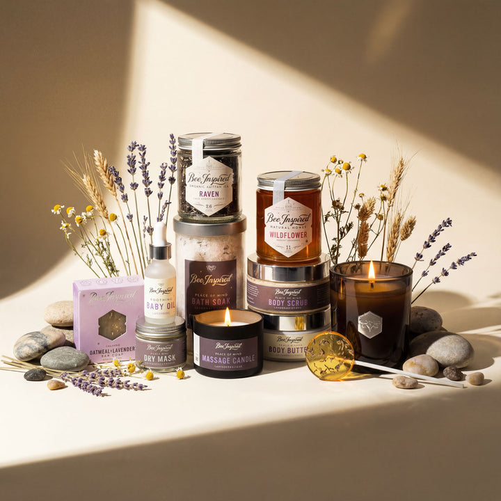 Collection of Bee &amp; Honey products including candles, soaps, and body butters on a neutral background.