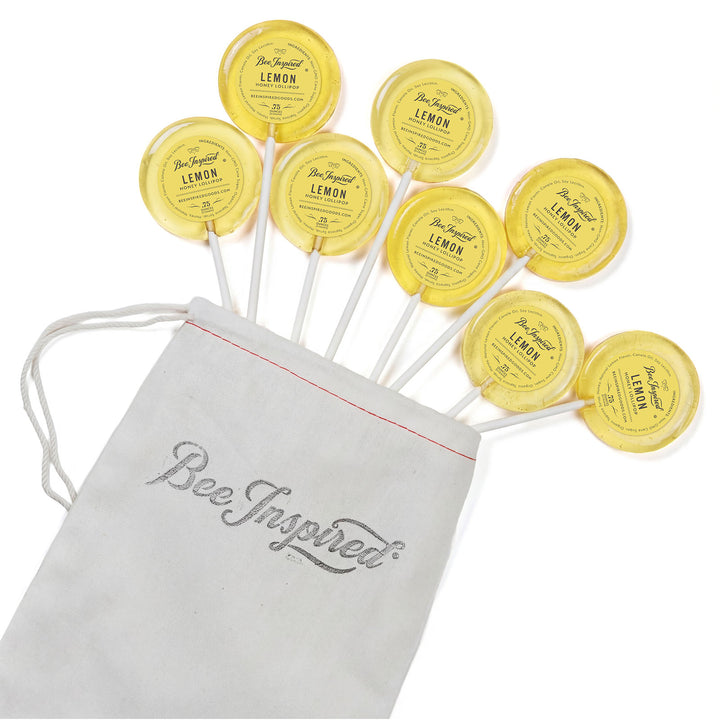 Yellow lemon-themed lollipops with a &