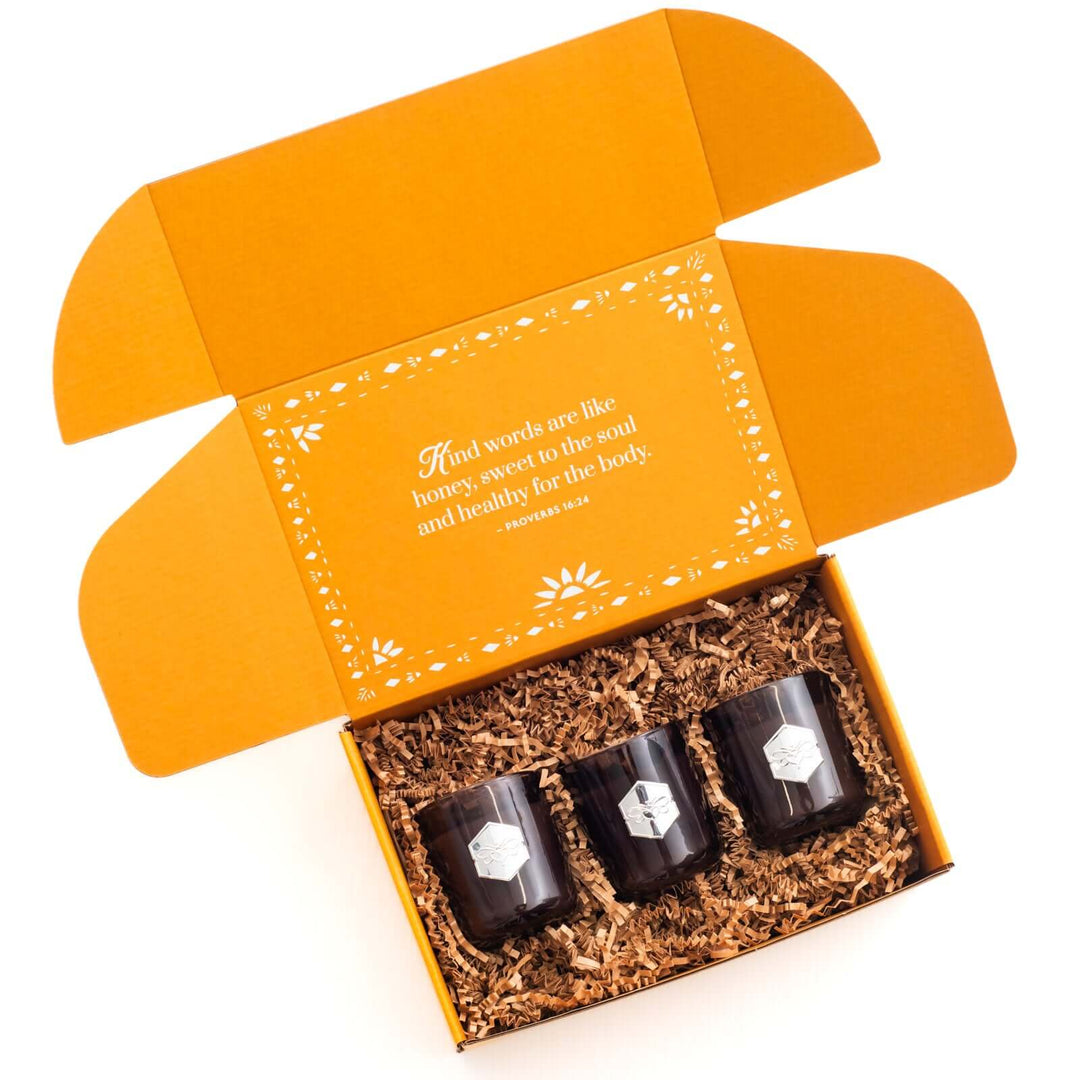 Mini luxe holiday candle set in open box against white 