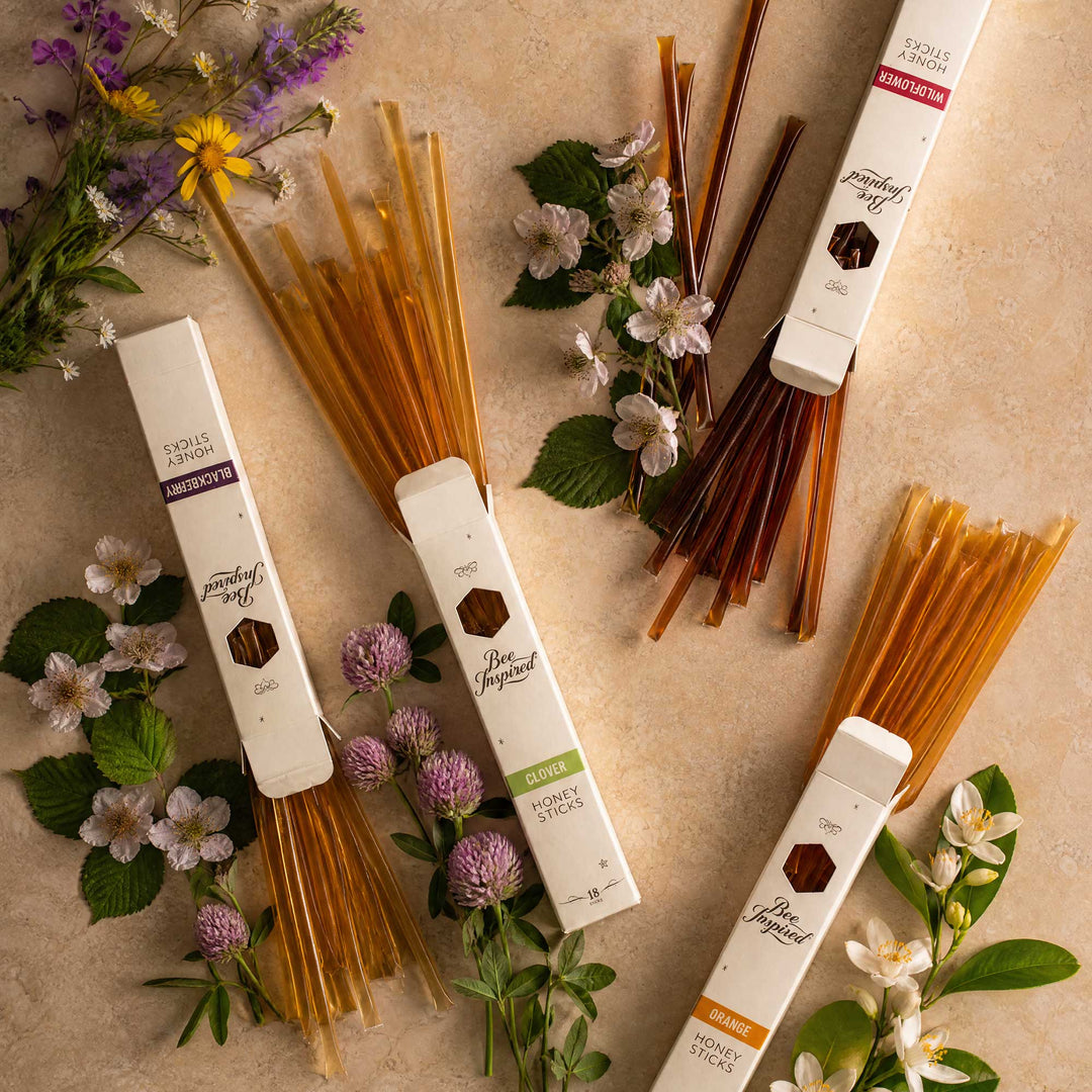 honey sticks with packaging on a beige background with flowers